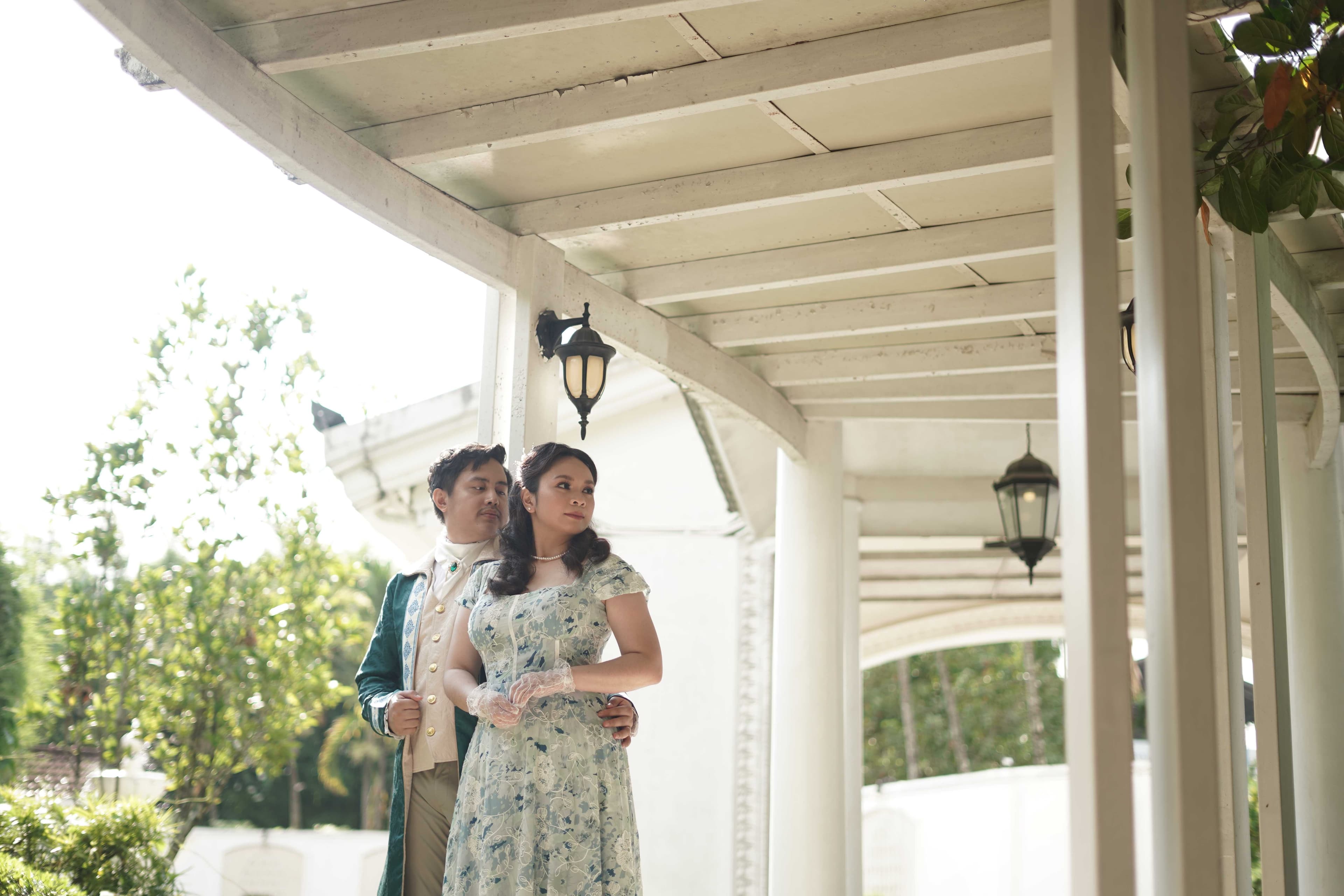 Miko and Jonalyn beneath a garden chandelier
