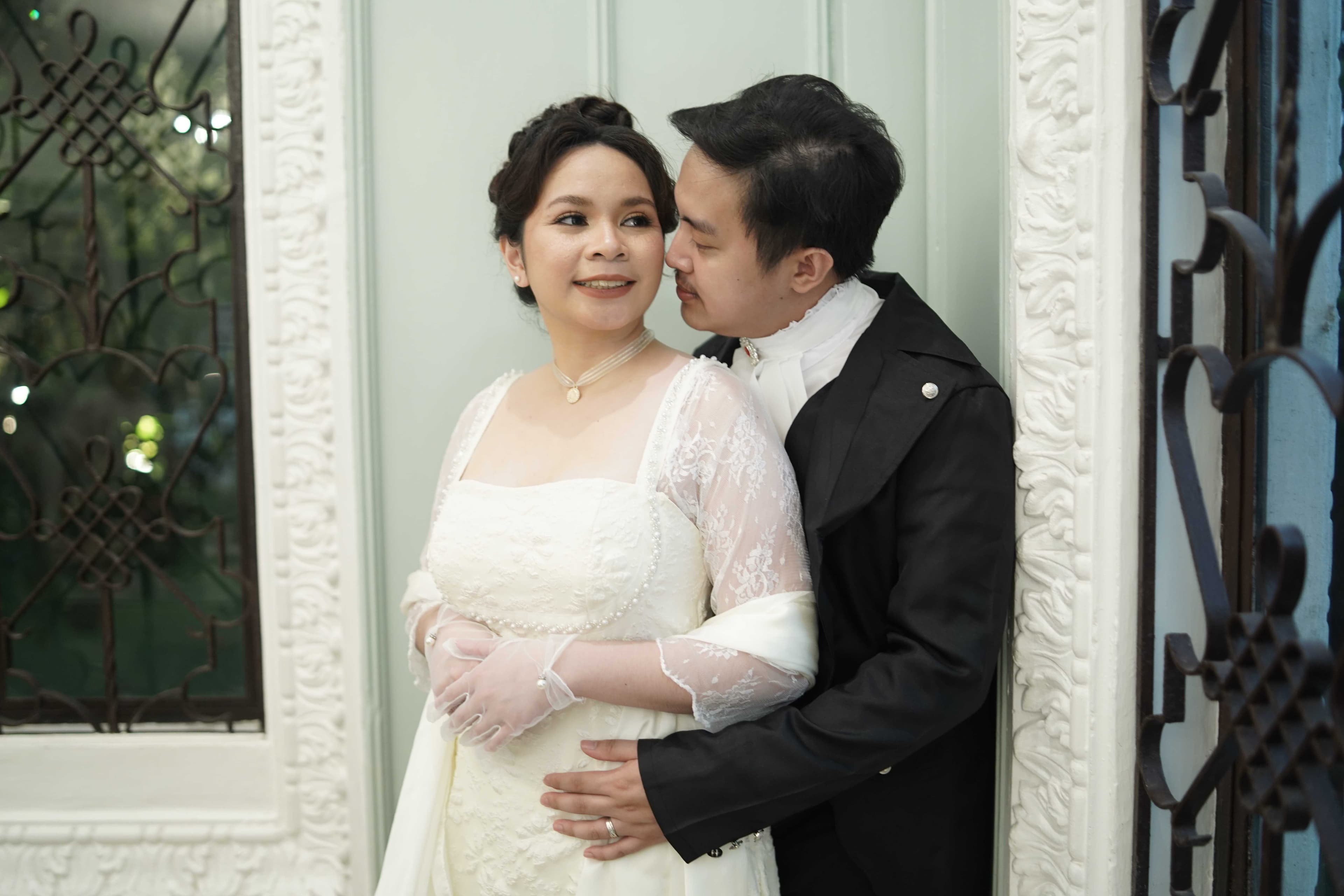 Miko and Jonalyn in white Regency wedding attire embracing