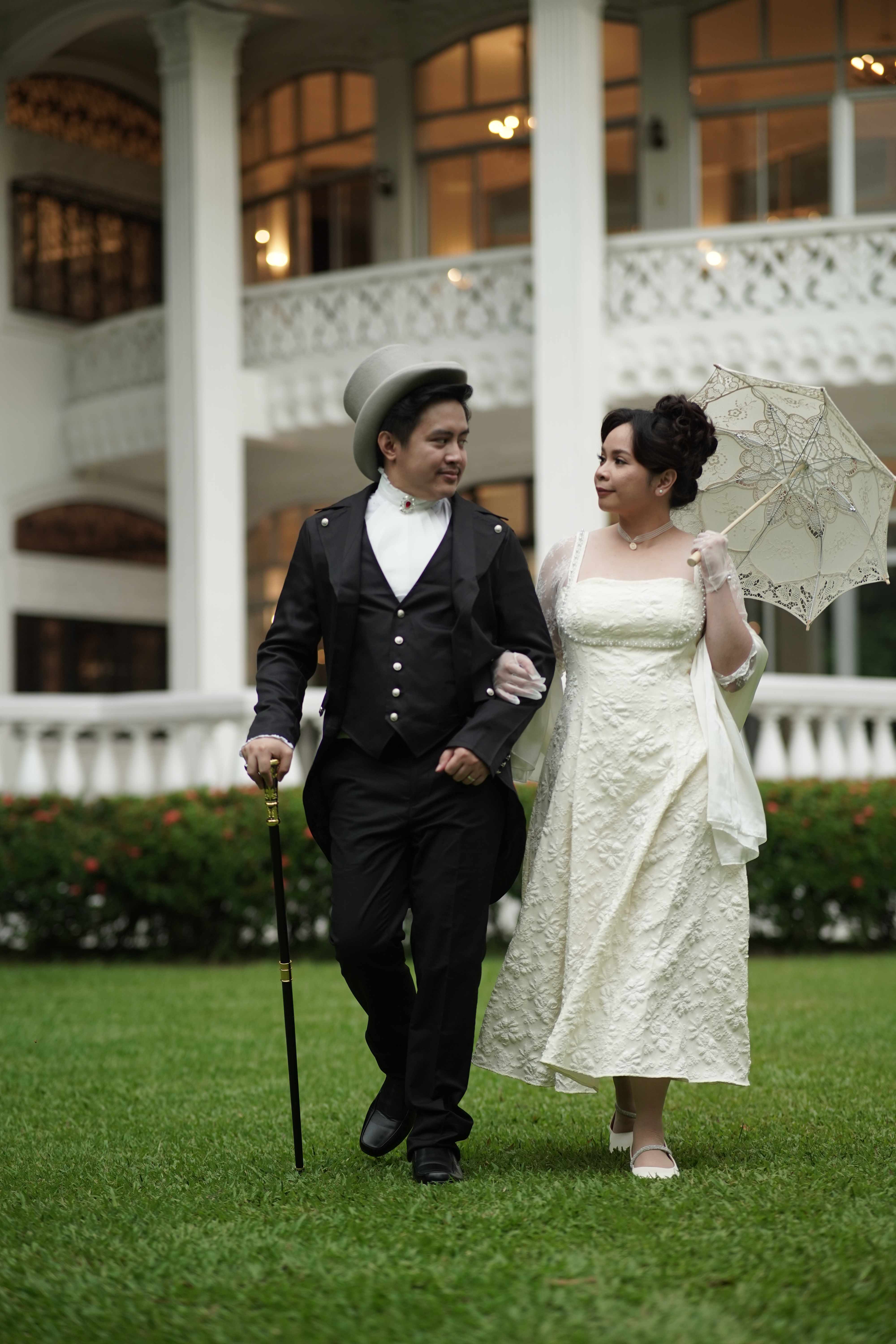 Miko and Jonalyn in white Regency wedding attire strolling the veranda