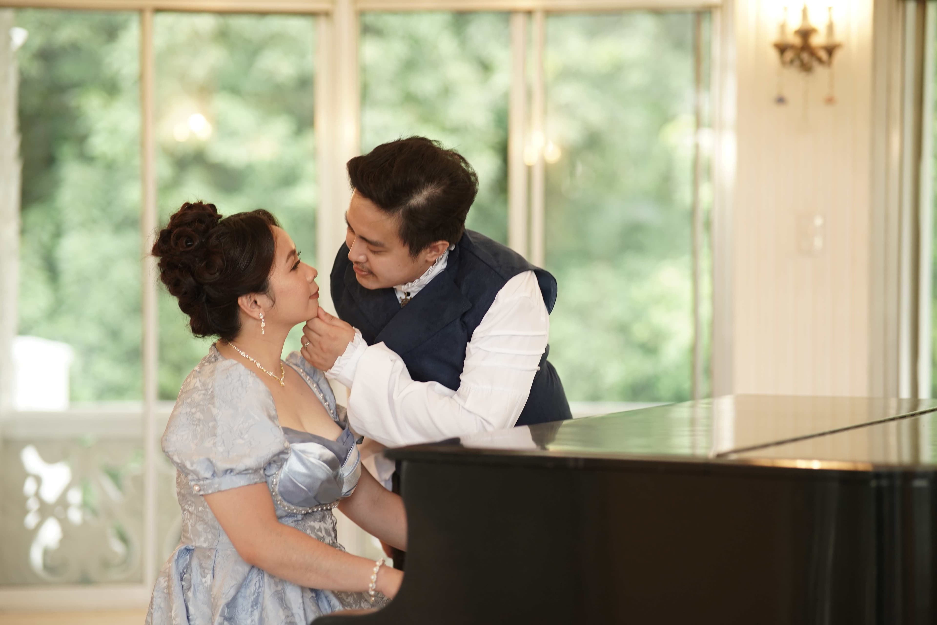 Miko and Jonalyn laughing together in period costume