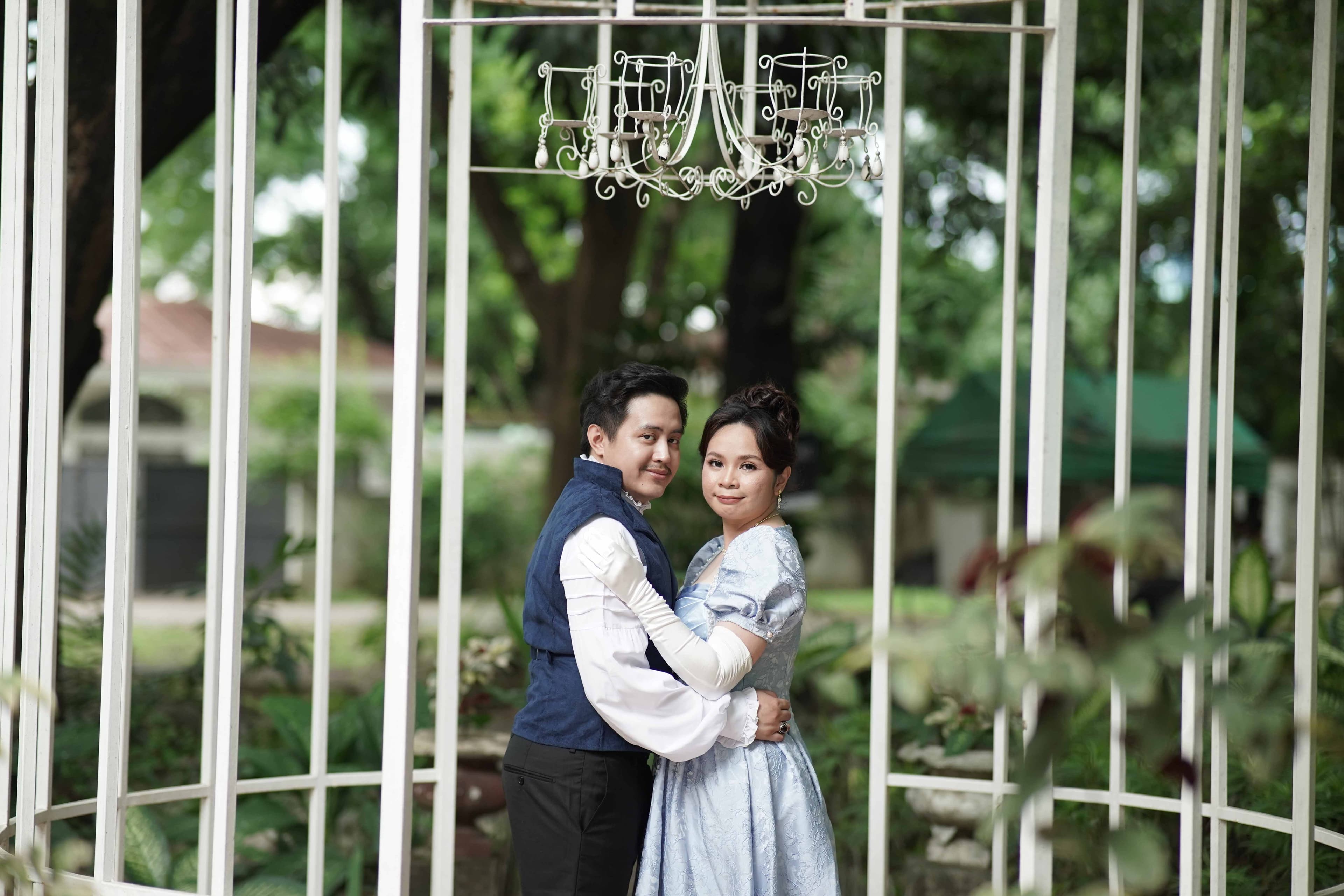 Miko and Jonalyn on a balcony at a grand white manor